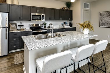 Large two and three bedroom townhomes with kitchen islands, stainless steel appliances, white, or dark cabinets, smart-home technology and full-sized washers & dryers at Sandstone Villas in Omaha, NE