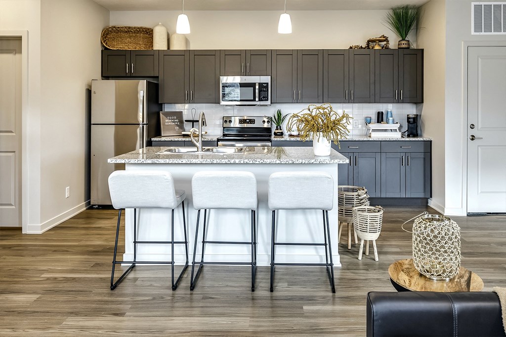 Two and three bedroom townhomes featuring golf course views, fill-size washer and dryer, stainless steel appliances, granite countertops, kitchen island, faux wood flooring and smart-home technology with keyless entry at Sandstone Villas in Omaha, NE