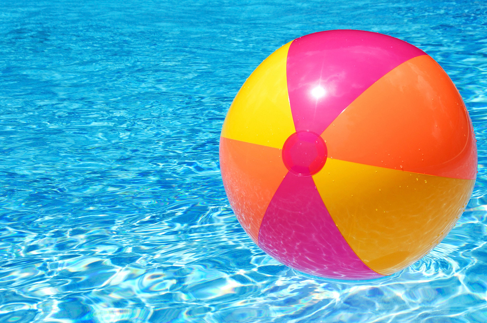 a colorful beach ball in a swimming pool