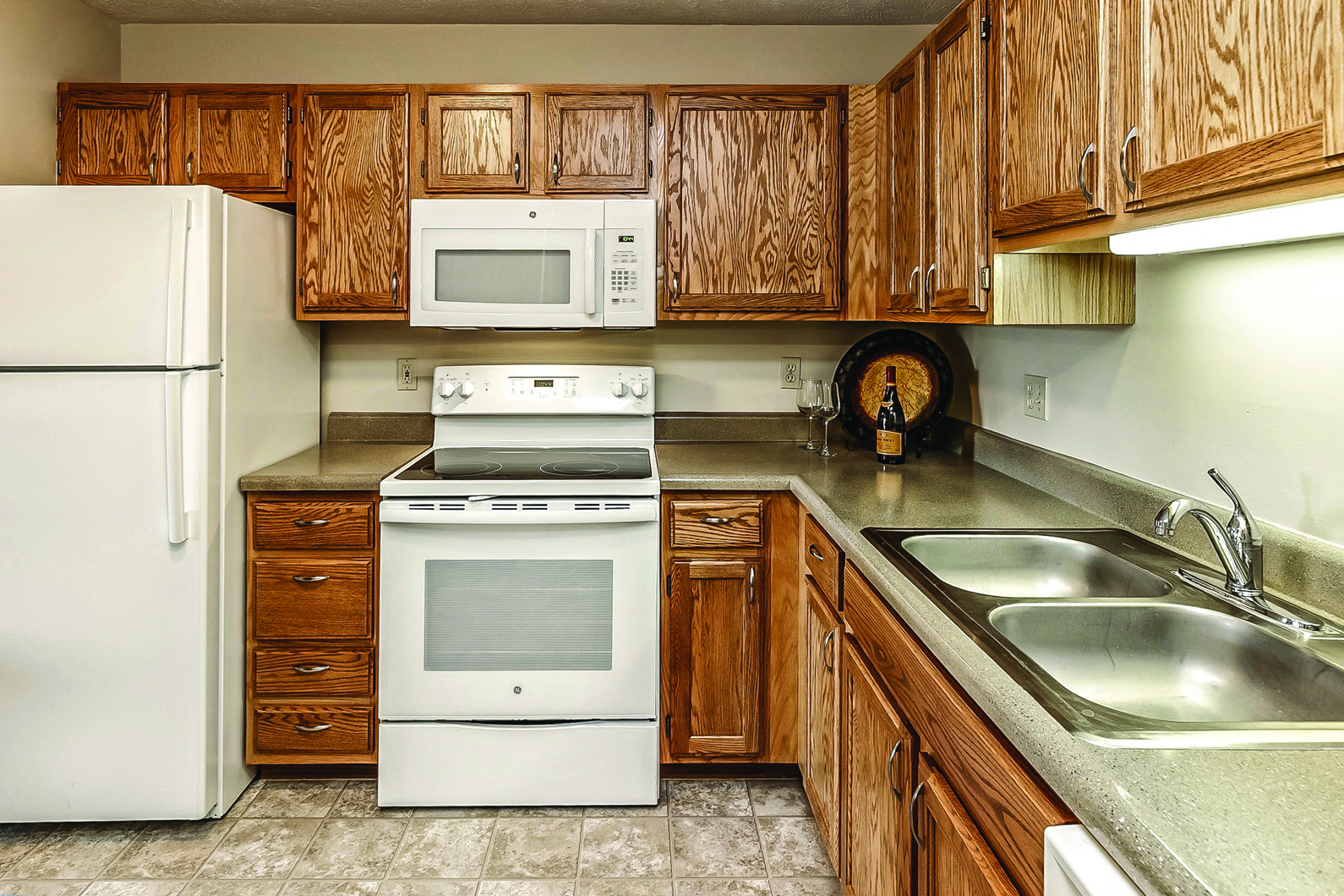 a kitchen with white appliances and wooden cabinets