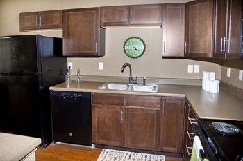 Dark cabinet kitchen at the Sterling at Grand Island apartments in Grand Island, NE - Photo Gallery 3