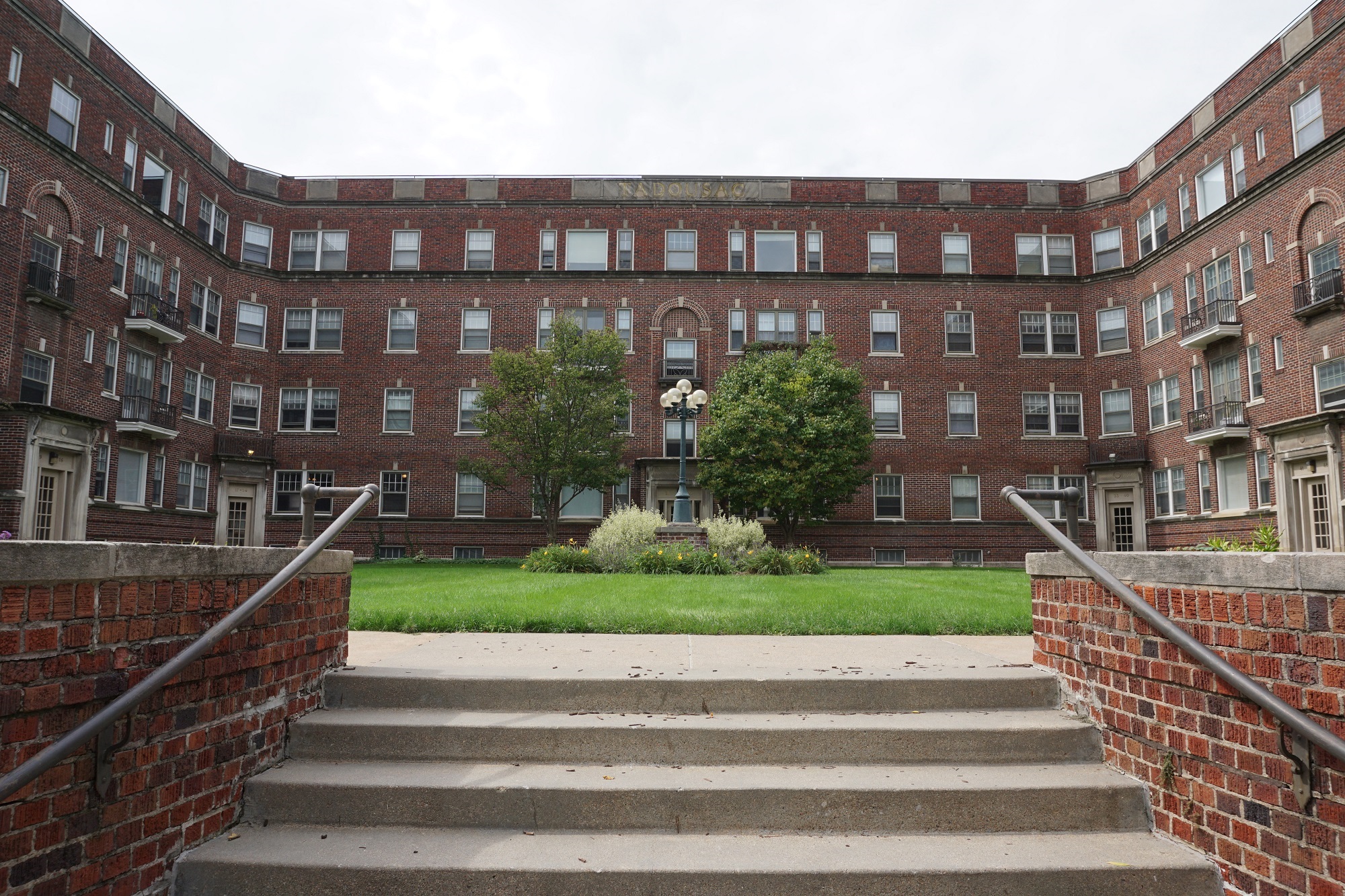 a large brick building with stairs in front of it