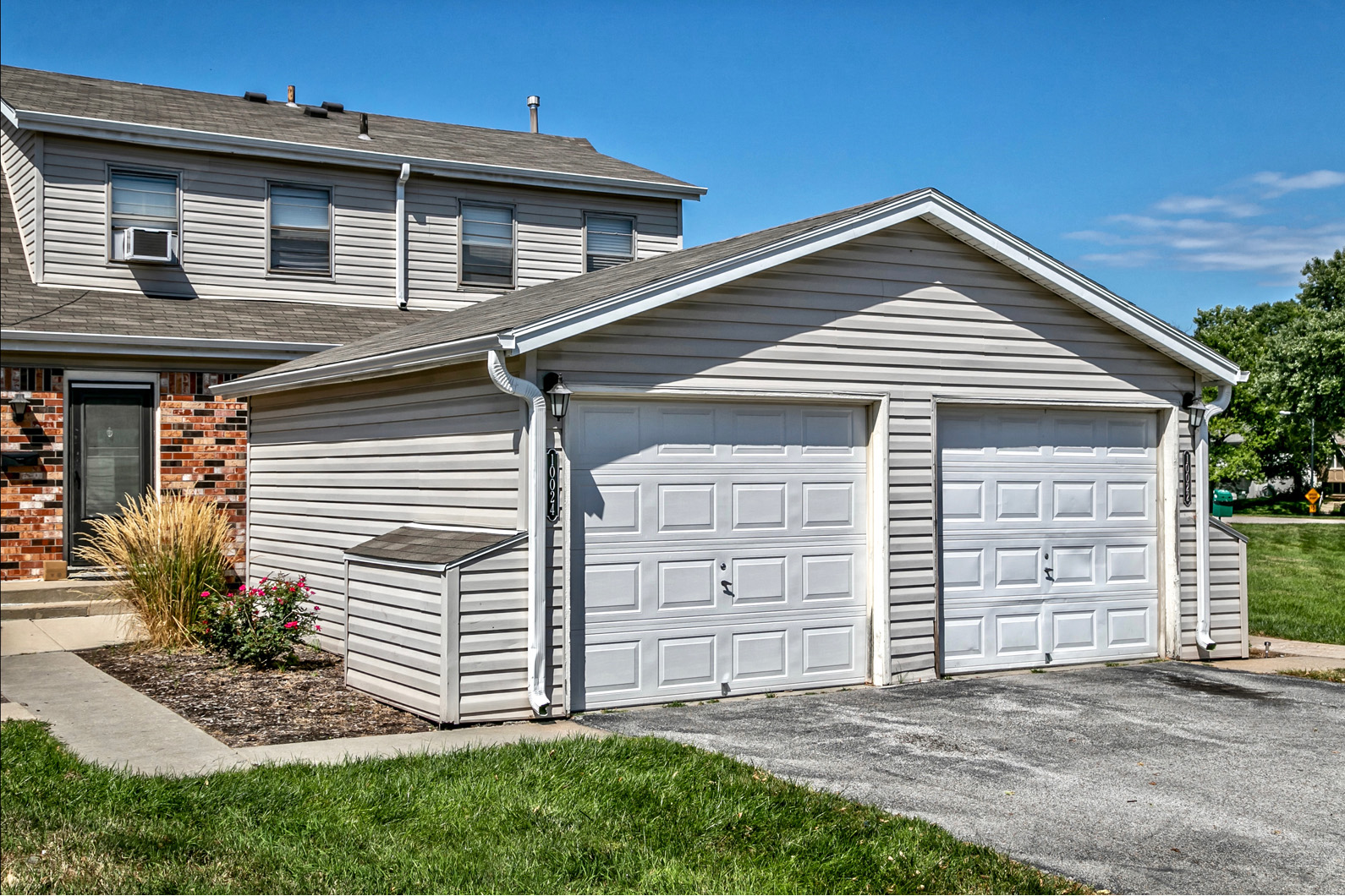 Townhome exterior with great landscaping and detached garages at Terrace Garden Townhomes