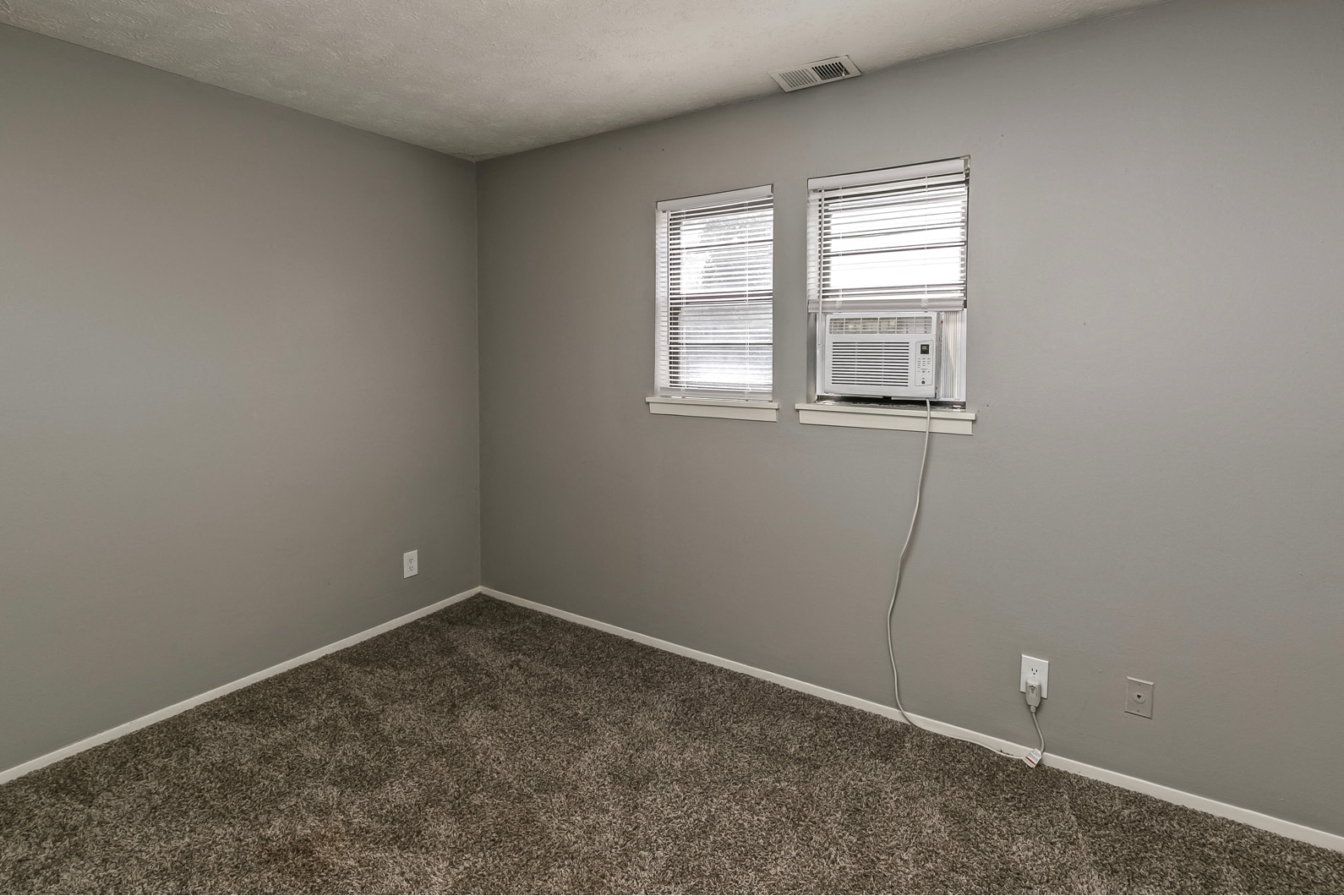 Large bedroom with window coverings at Terrace Garden Townhomes