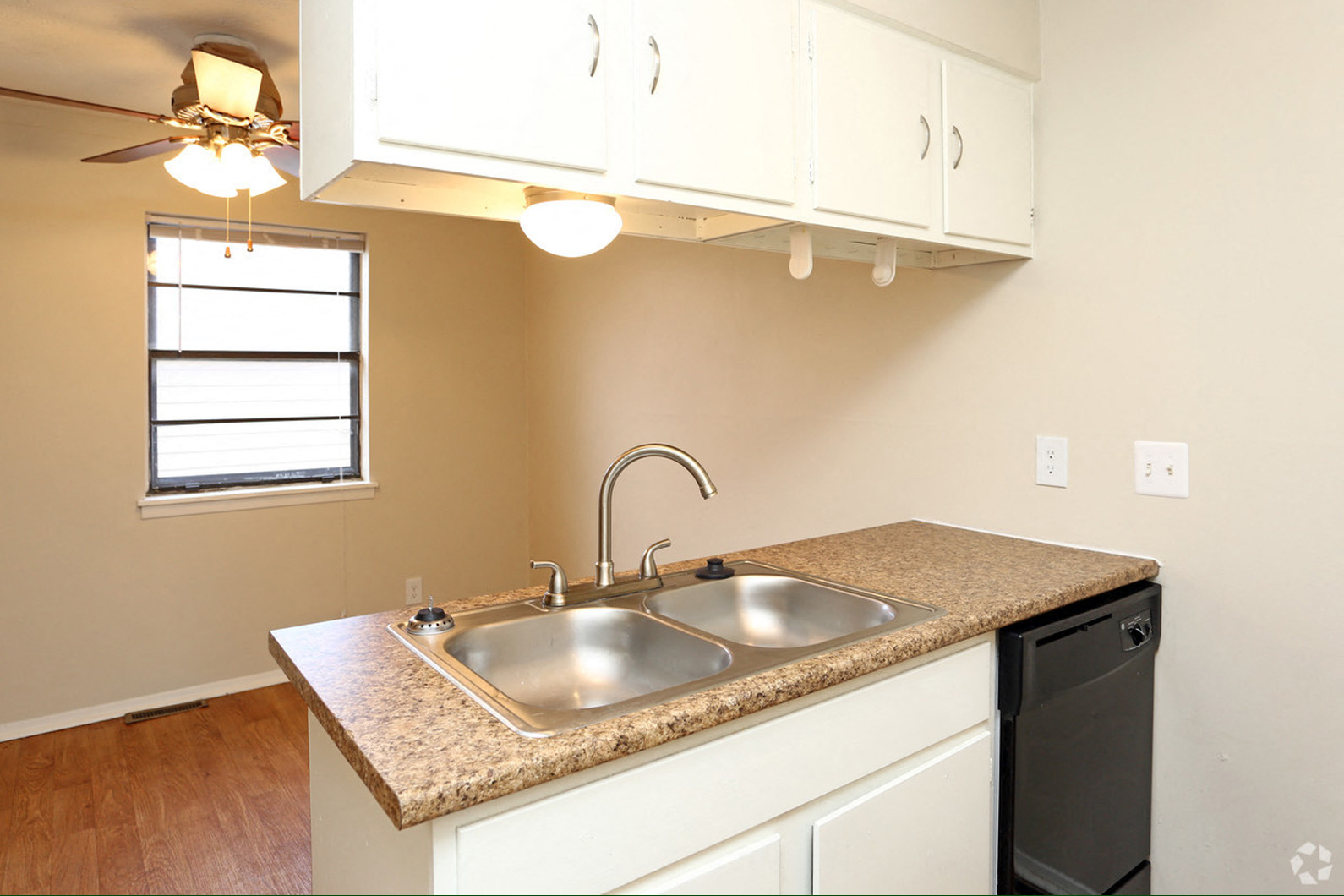 a kitchen with a sink and a window