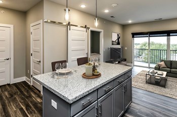 Large kitchens with white or black backsplashes at The Mill Apartments in Benson, NE - Photo Gallery 2