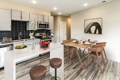 a kitchen and dining room with a table and chairs