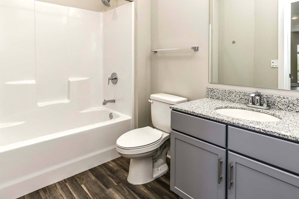 Large bathrooms with granite countertops at The Mill Apartments in Benson, NE