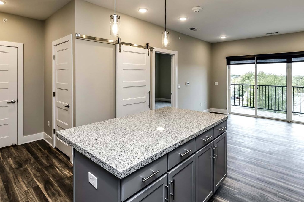 Large kitchens with white or black backsplashes at The Mill Apartments in Benson, NE