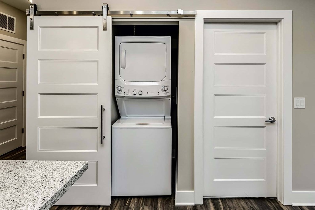 In-unit laundry with barn doors at The Mill Apartments in Benson, NE