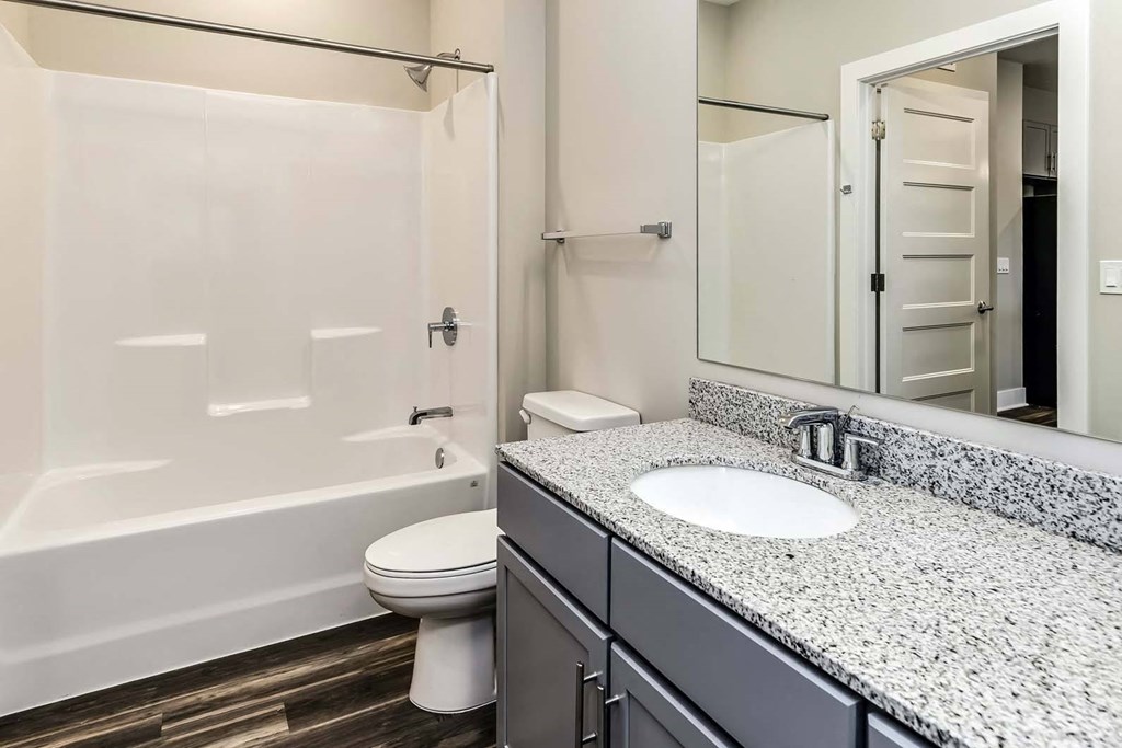 Large bathrooms with granite countertops at The Mill Apartments in Benson, NE