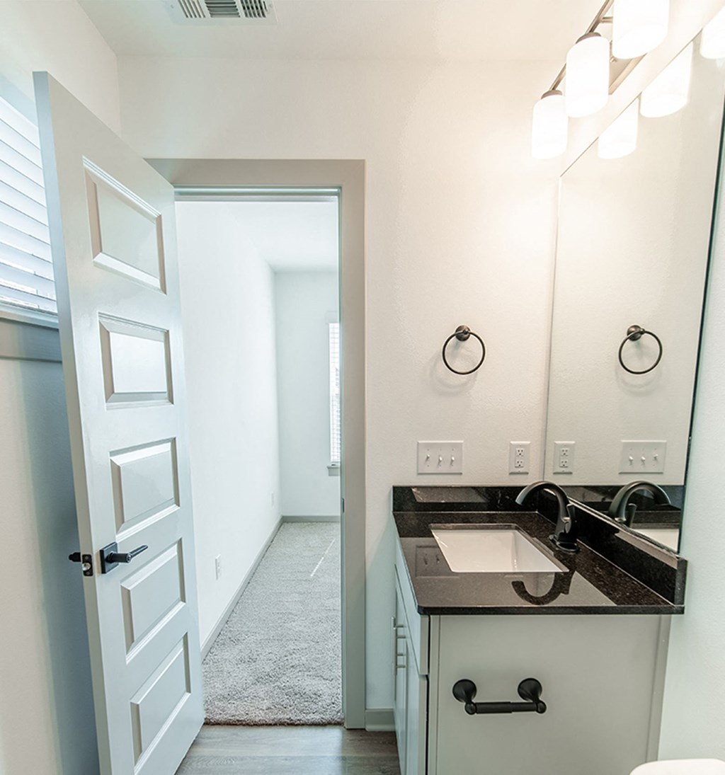 Bathroom with granite countertops at Shadowbrooke Village in Rogers, AR