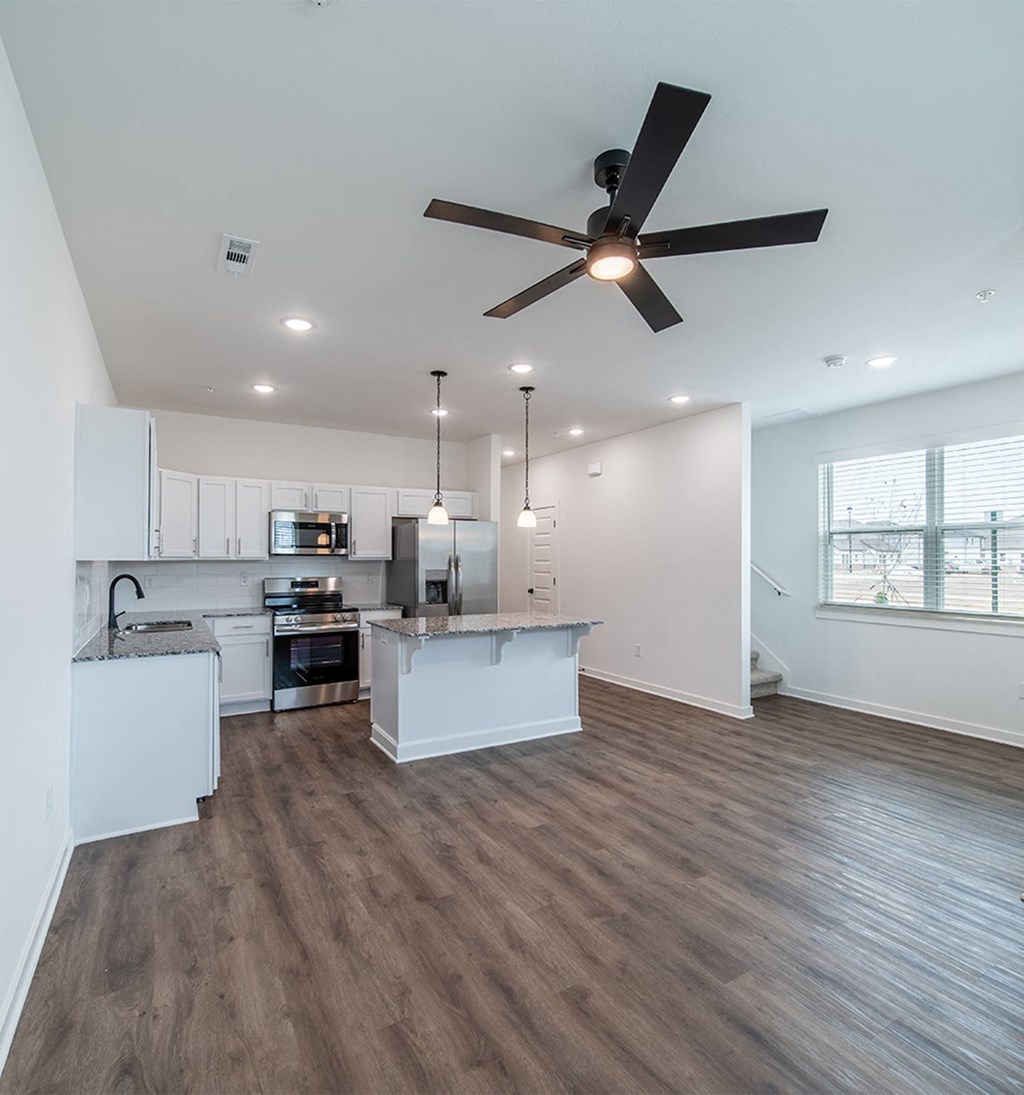 Spacious living room with premium hard wood flooring at The Grove in Rogers, AR