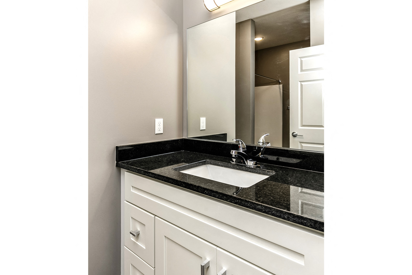 Large bathroom vanity with white cabinets at The Apartments at Lux 96 in Papillion, NE