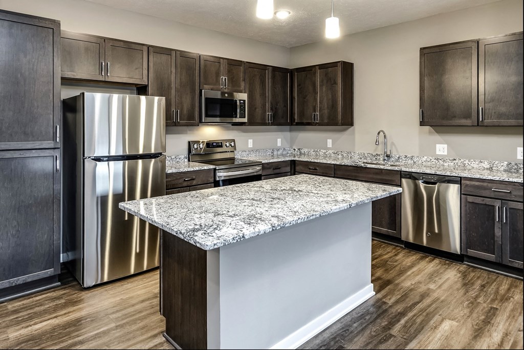Dark Cabinet kitchen with large island at LIV 156 Apartments in Omaha, NE