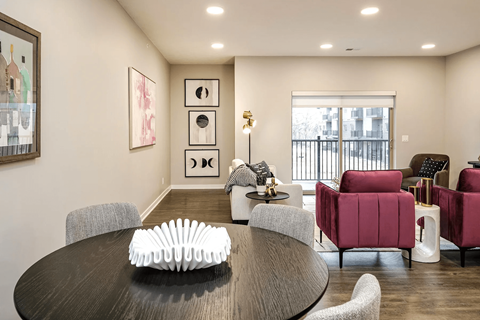 A modern dining room with a round table and chairs.