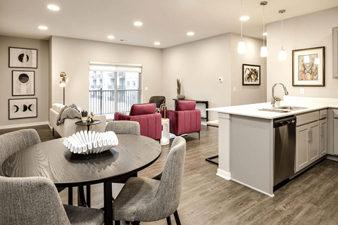 A modern kitchen with a dining table and chairs.