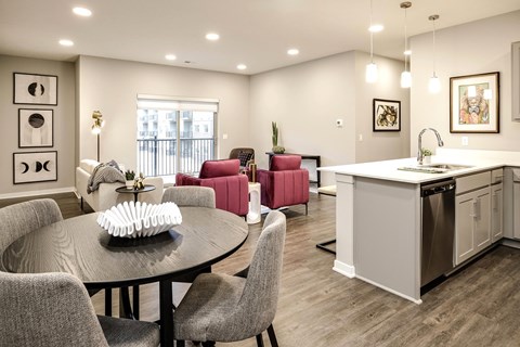 A modern kitchen and dining area with a round table and chairs.