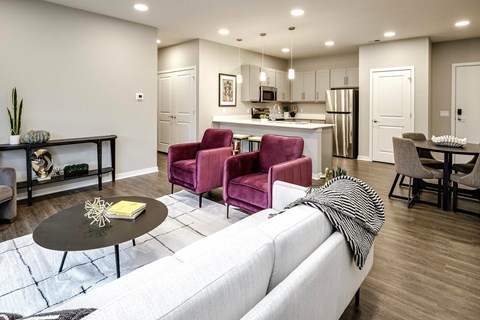 A modern living room with a white sofa and a black coffee table.