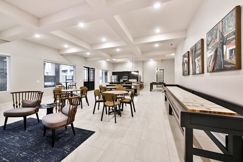 A dining room with a long table and chairs.