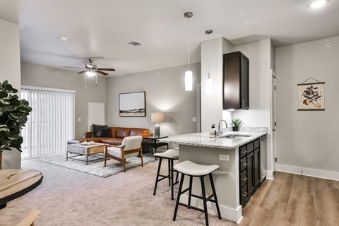 A modern kitchen with a bar stool and a countertop.