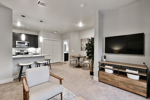 A modern living room with a grey sofa and a wooden coffee table.