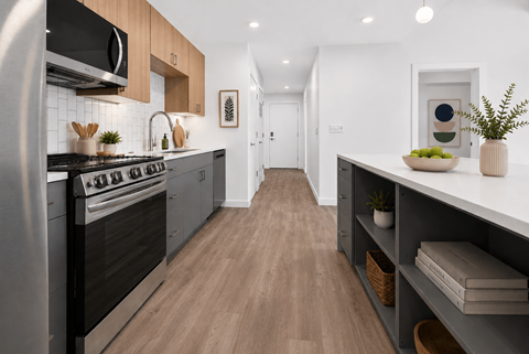 A modern kitchen with a stainless steel oven and wooden cabinets.