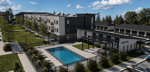 A large building with a pool in front of it.