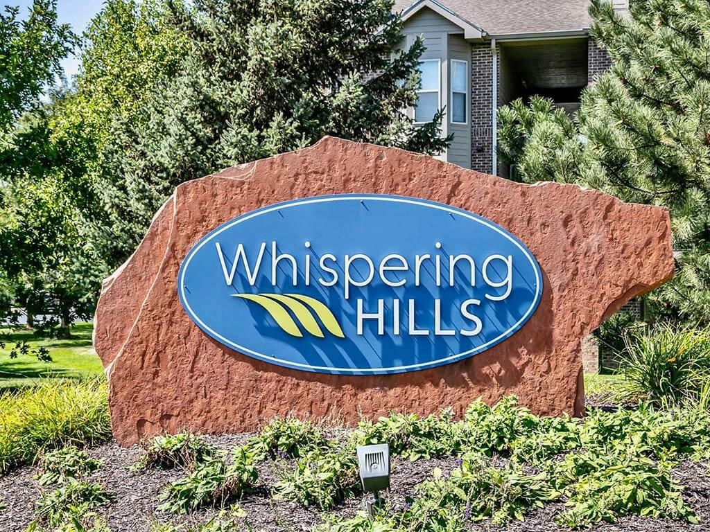 Property signage at Whispering Hills Apartments in Omaha, NE