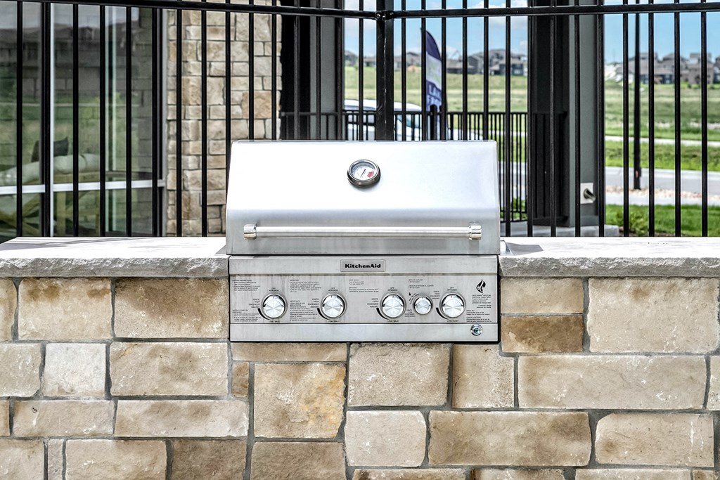 Pool patio with fire pit  and outdoor grill at The Westline at Flanagan Lake in Omaha, NE