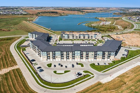 A large building with a parking lot in front of it.