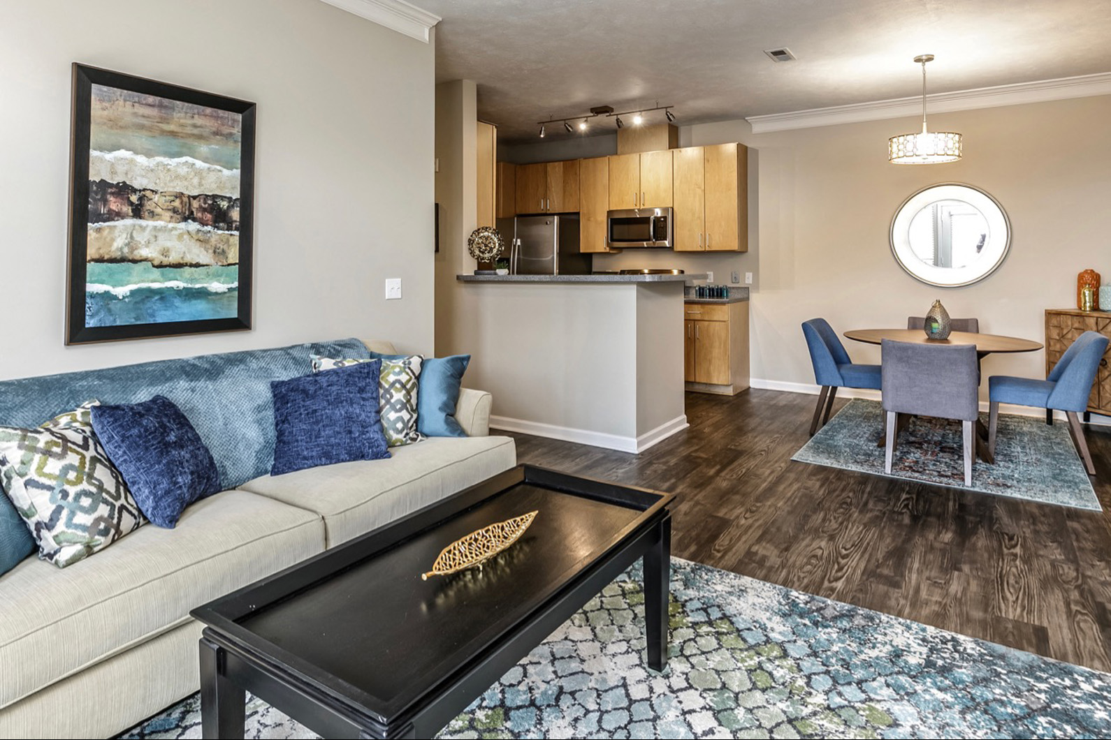 a living room with a couch and a table and a kitchen