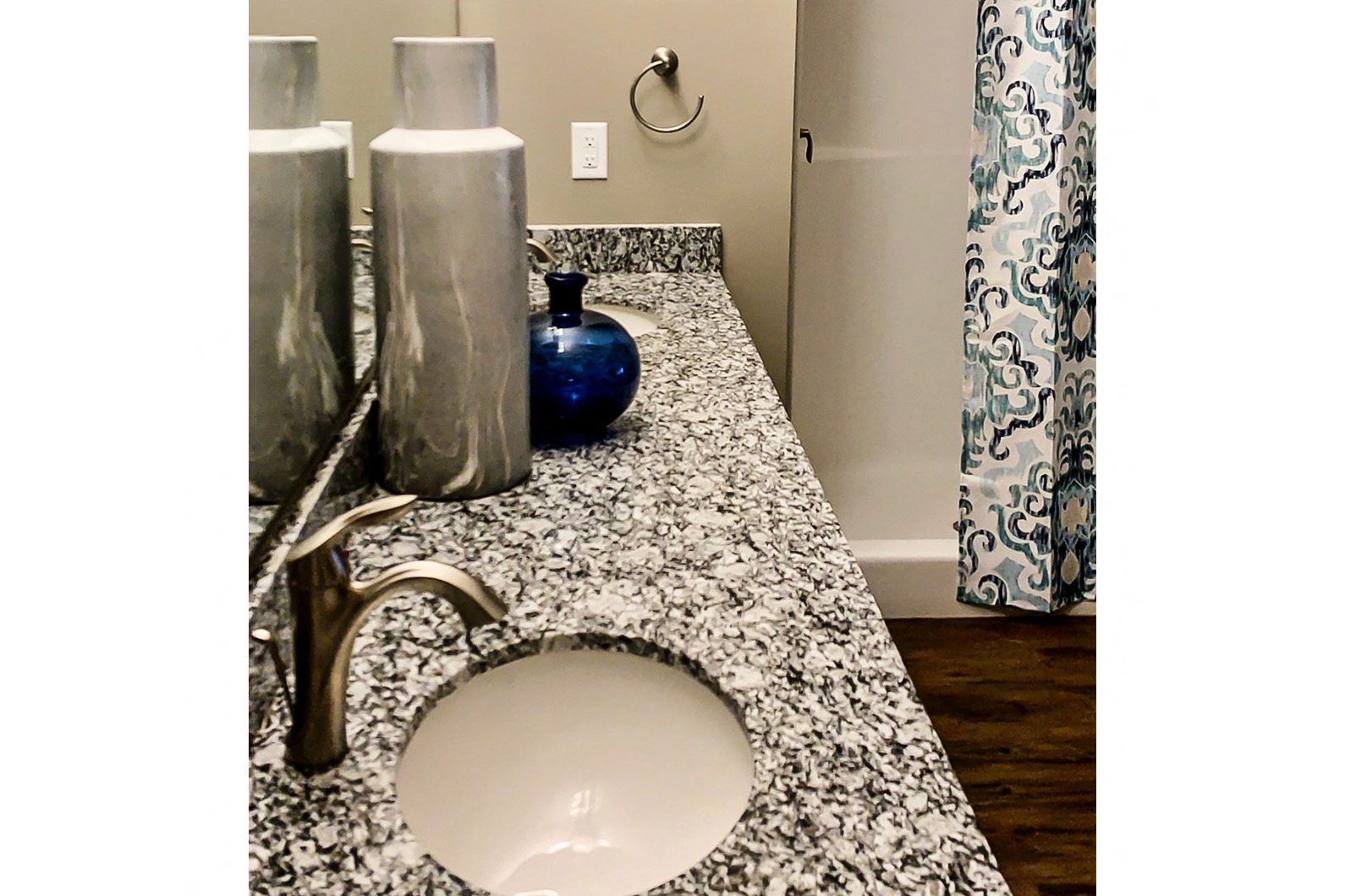 a bathroom with a marble counter top and a sink