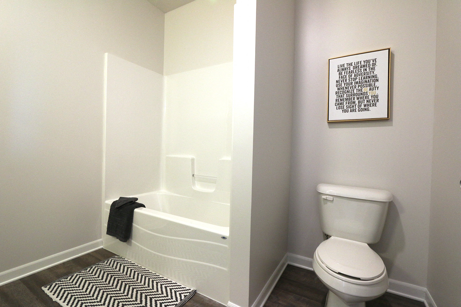 a small bathroom with a toilet and a bath tub