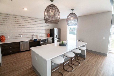 A kitchen with a white counter and a white fridge.