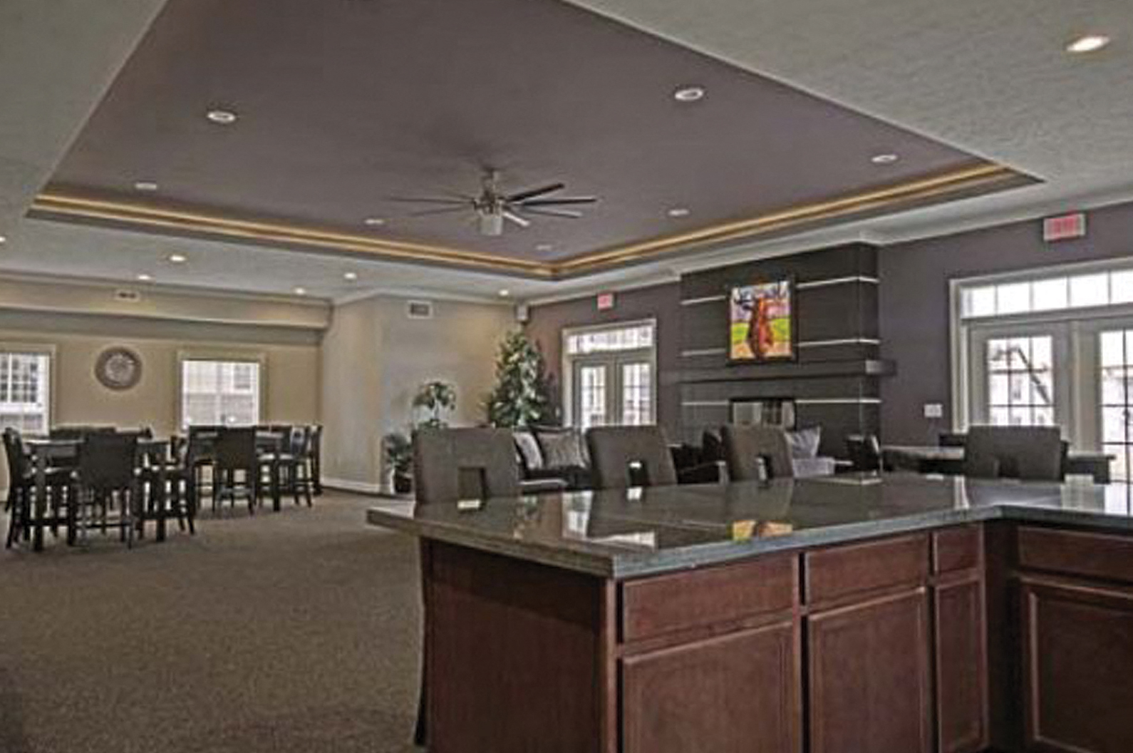 a large room with a counter and chairs and a table