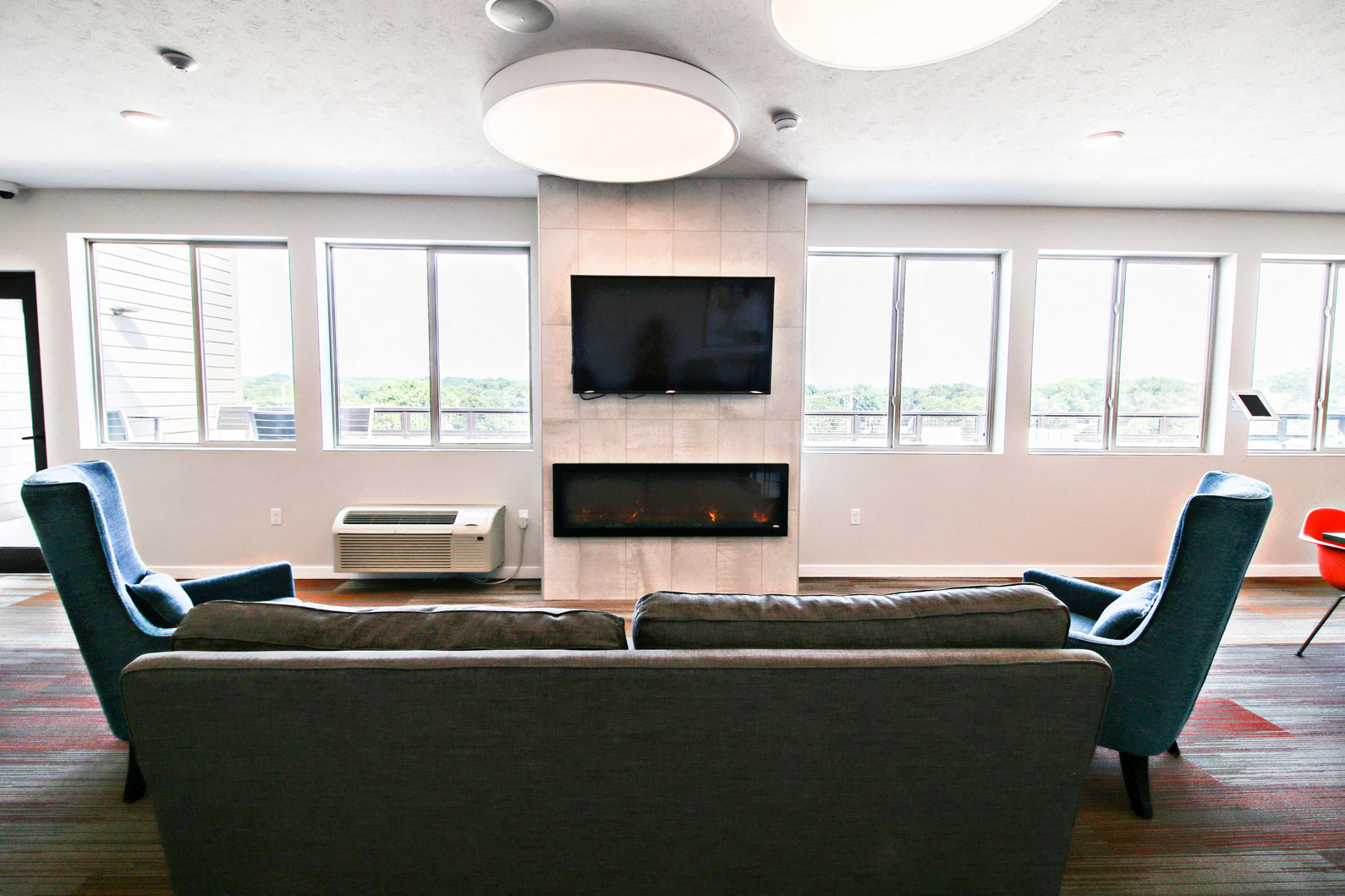 a living room with a couch and chairs and a fireplace