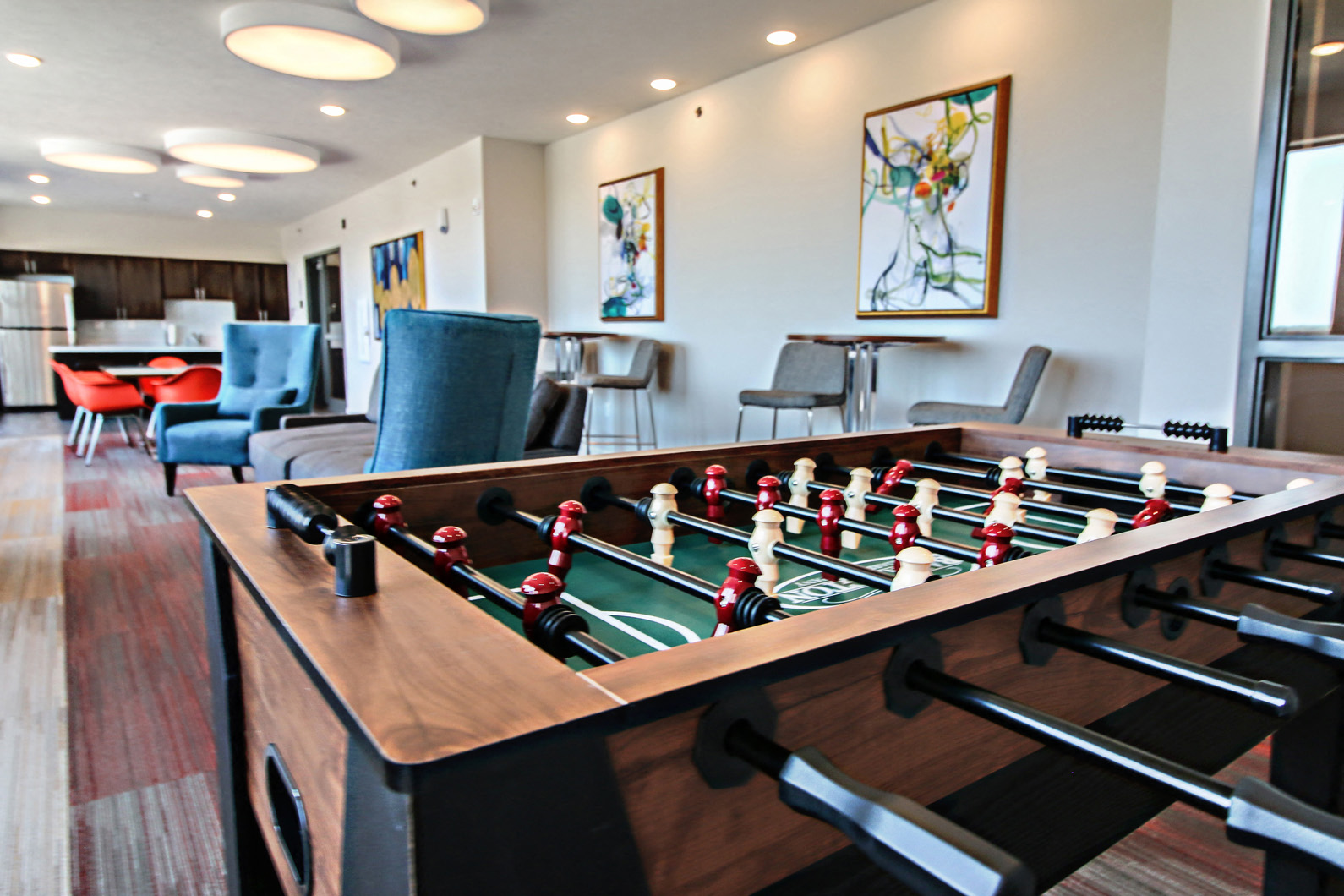 a game room with a foosball table and chairs