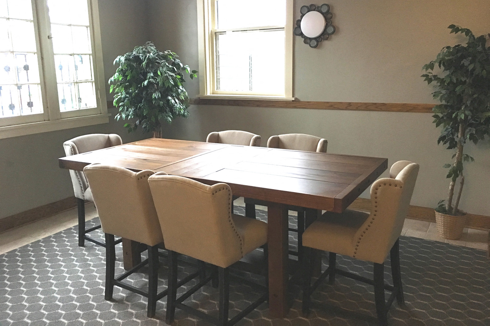 a dining room with a wooden table and chairs