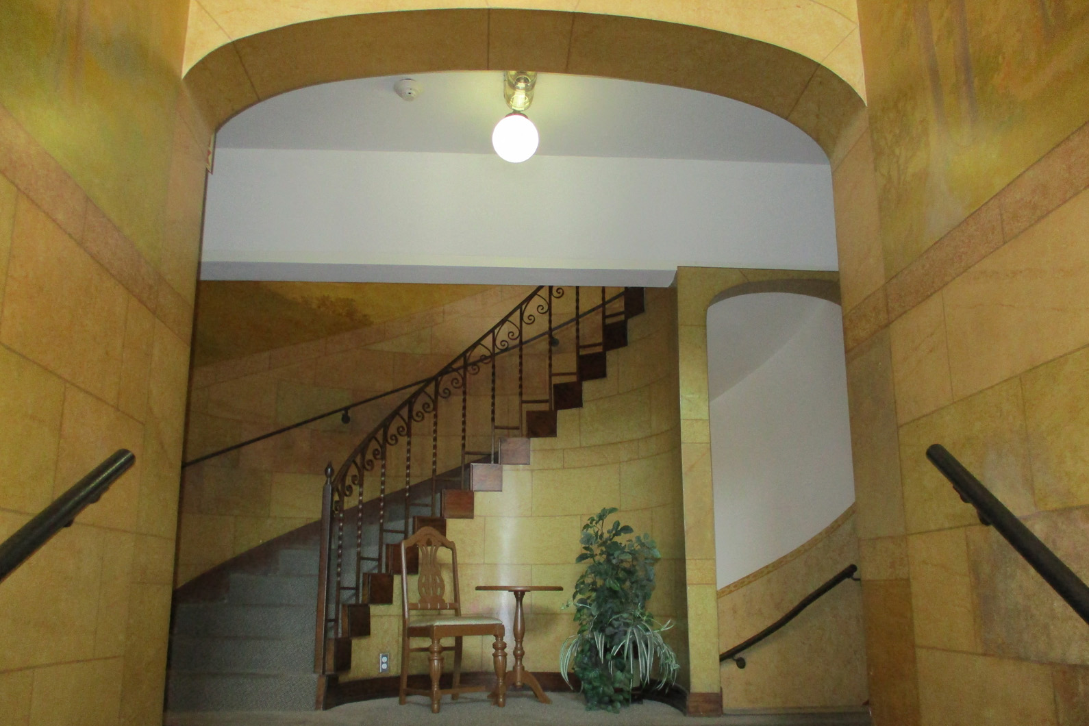 a staircase in a building with a table and chairs