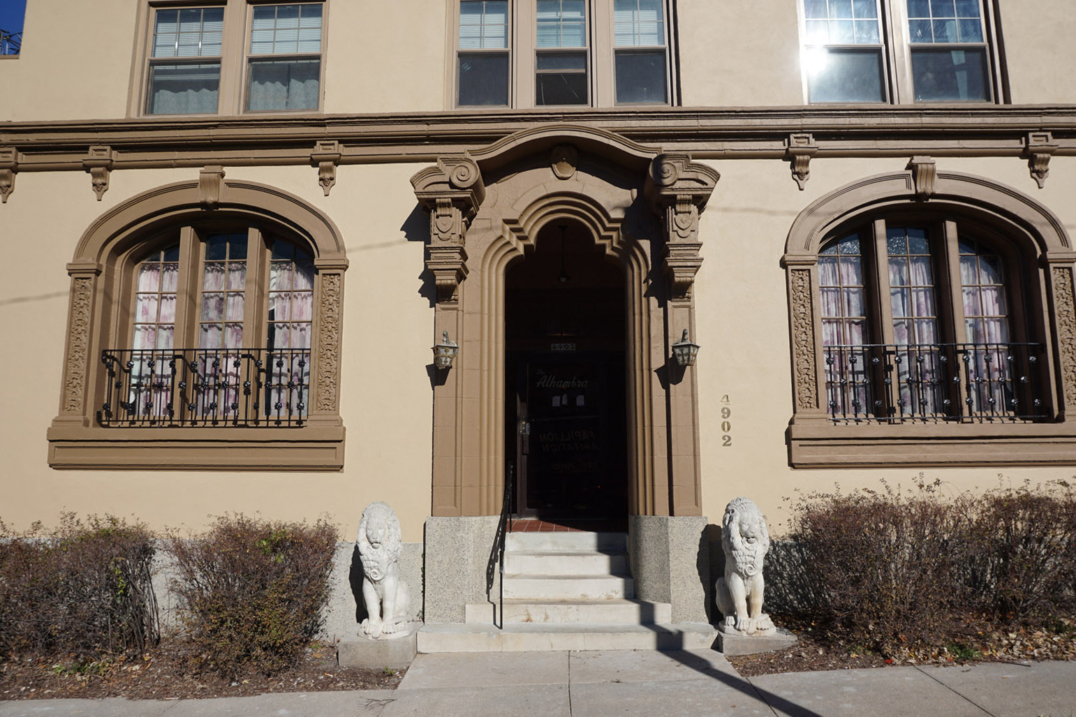 the front of a building with two lions in front of it