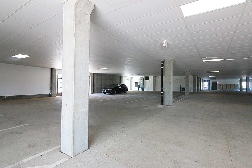 an empty parking garage with a car parked in it