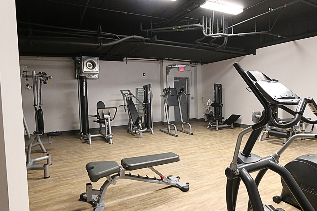 a workout room with various exercise equipment in a studio space