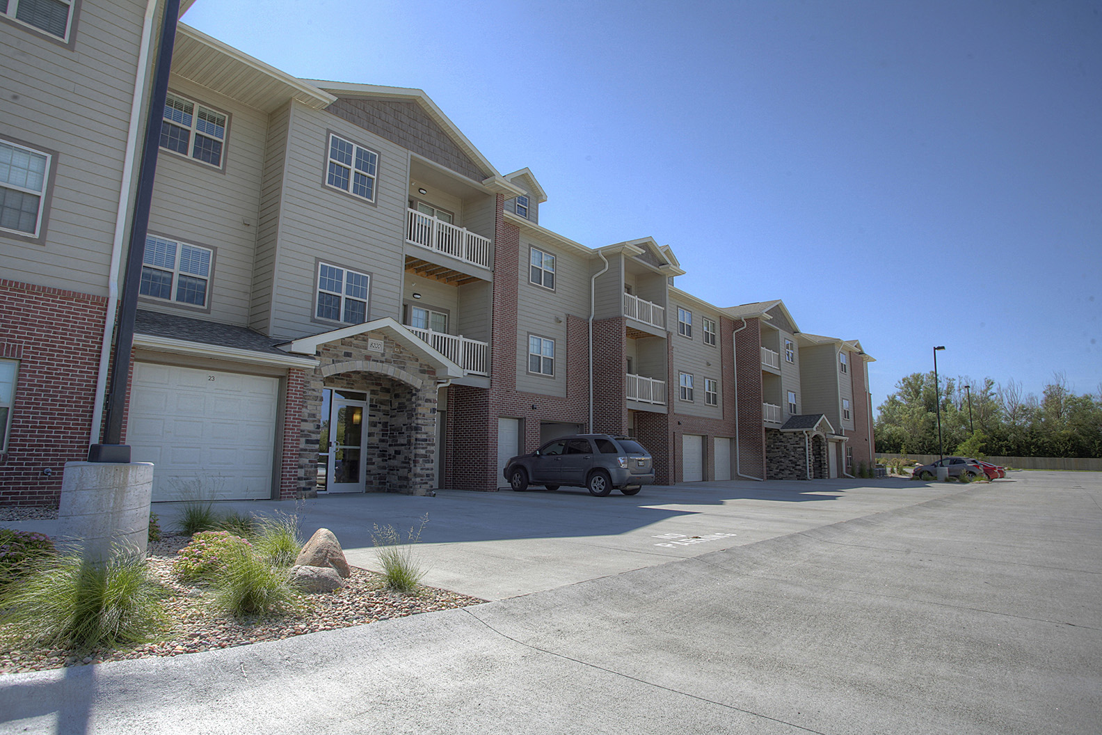 an apartment building with a car parked in front of it