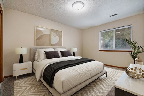 A bedroom with a large bed, two lamps, and a painting on the wall.
