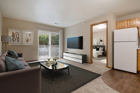 A living room with a brown couch and a black coffee table.