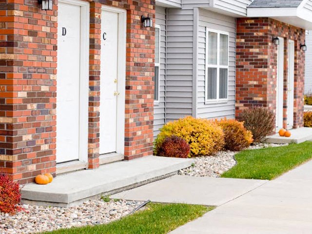 a house with pumpkins on the front porch