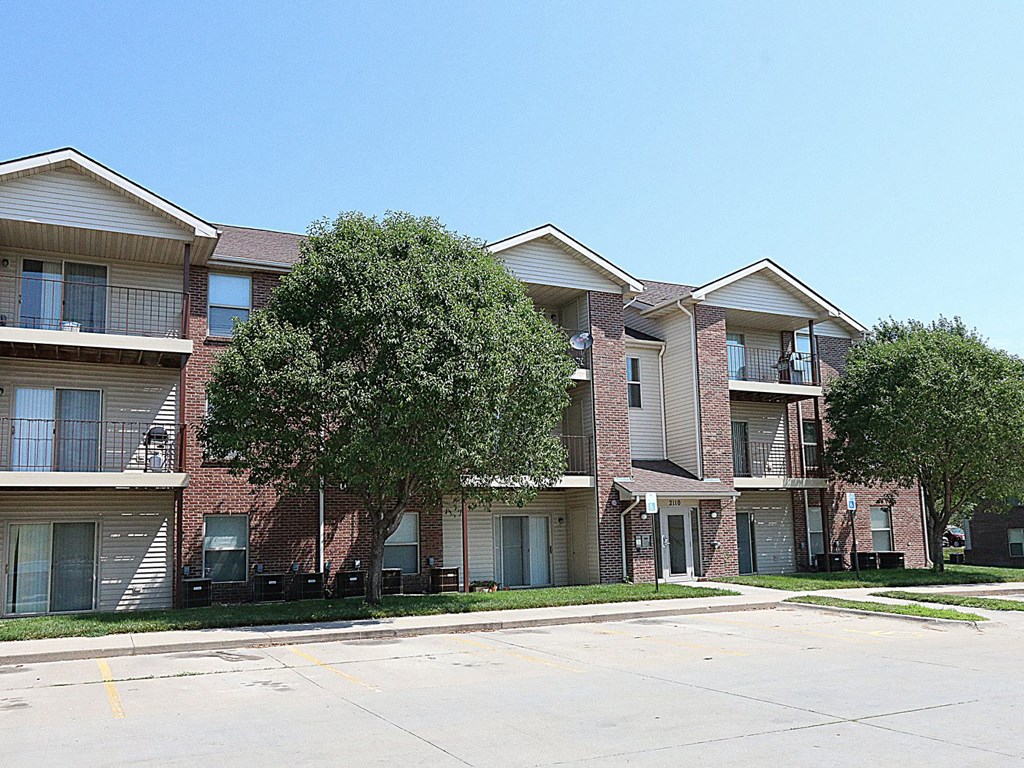 an apartment building with a street in front of it