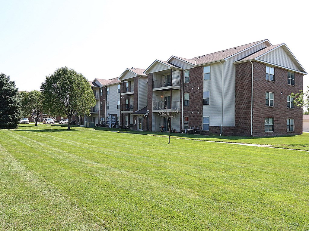 a large lawn in front of an apartment building