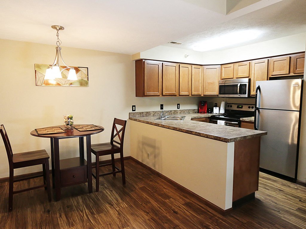 full kitchen with stainless steel appliances and a small table